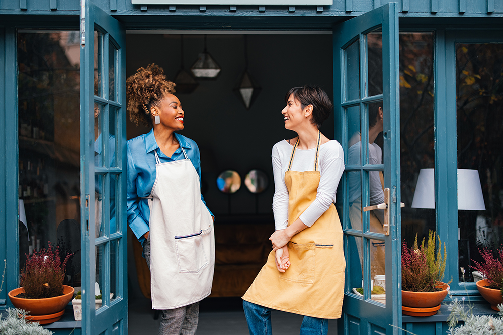 Two women at the front doors of a store